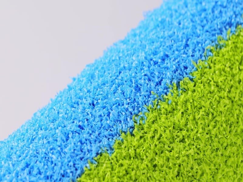 Factory worker measuring turf roll width